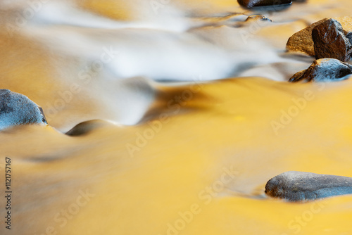 Obraz na płótnie Autumn landscape of the Little River captured with motion blur and illuminated by reflected color from sunlit autumn foliage and blue sky overhead, Great Smoky Mountains National Park, Tennessee, USA w salonie