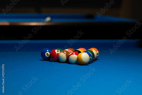 Billiard Setup on a Blue Pool Table Under Soft Lighting
