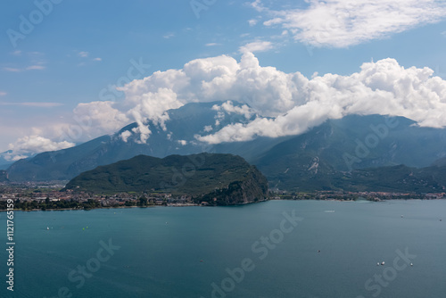 Panoramic view of idyllic lakeside town Nago Torbole seen from hiking and cyclist trail Sentiero del Ponale at Garda Lake, Trentino, North Italy. Monte Brione surrounded by mountains of Garda Hills photo