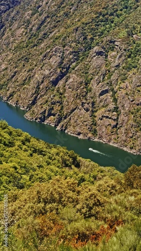 Boat Cruising Through Verdant River Canyon