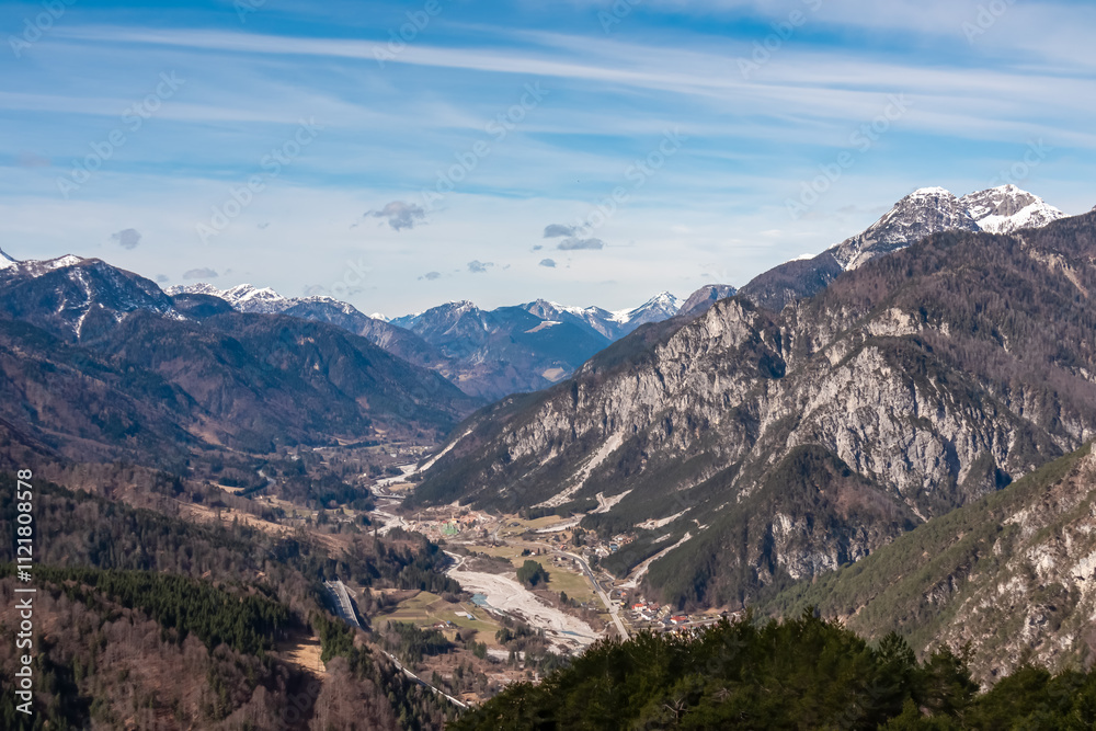 Aerial view of valley Val Canale and alpine village Malborghetto Ugovizza surrounded by snow capped mountains peaks of Julian and Carnic Alps, Friuli Venezia Giulia, Italy. Wanderlust Italian Alps Aerial view of valley Val Canale and alpine village Malborghetto Ugovizza surrounded by snow capped mountains peaks of Julian and Carnic Alps, Friuli Venezia Giulia, Italy. Wanderlust Italian Alps