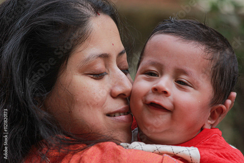 A photo of a Bengali Mother Sharing a Joyful Moment With Her Son on a Winter Day in Santiniketan, West Bengal, India photo