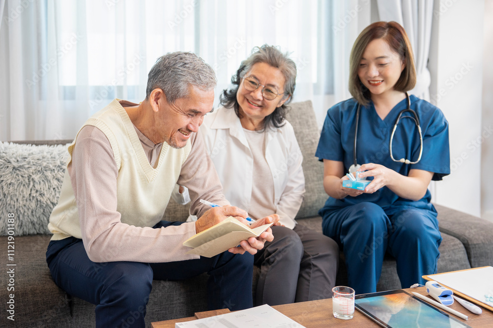 Obraz premium asian senior man taking notes for his wife while a visiting nurse give advice on taking medication,concept of elderly health care,health insurance,home health care
