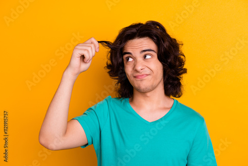 Portrait of attractive handsome stylish trendy macho boy guy combing long furfur isolated on yellow background photo