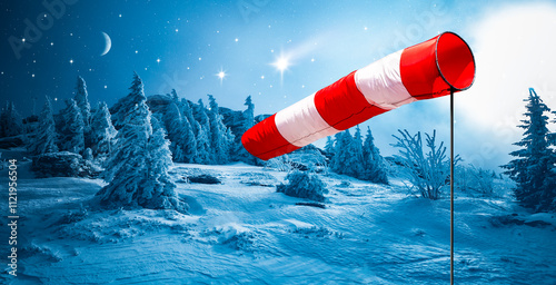 Eine Windfahne vor verschneite Winterlandschaft