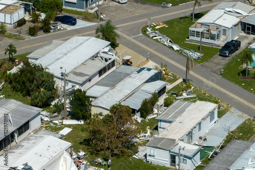 Consequences of natural disaster. Severely damaged houses after hurricane Ian in Florida mobile home residential area photo