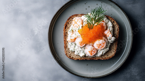 Open-faced shrimp sandwich with caviar on dark rye bread photo