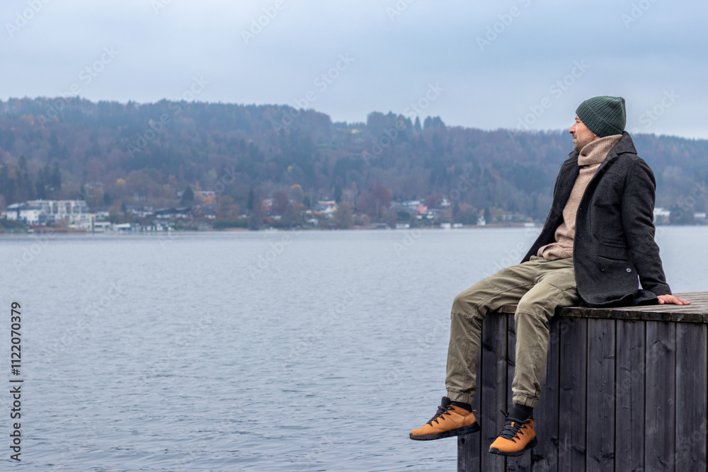 Fototapeta premium Man sitting on wooden deck