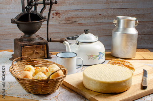 Cheese and cheese bread, a beautiful breakfast table with Brazilian delicacies and accessories on rustic wood, selective focus. photo