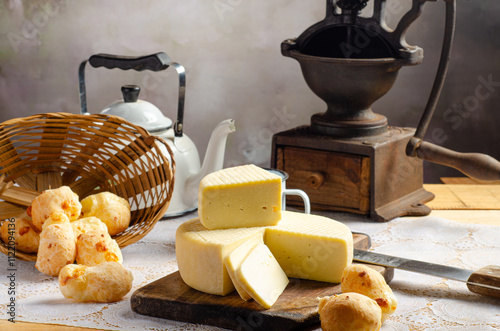 Cheese and cheese bread, a beautiful breakfast table with Brazilian delicacies and accessories on rustic wood, selective focus. photo