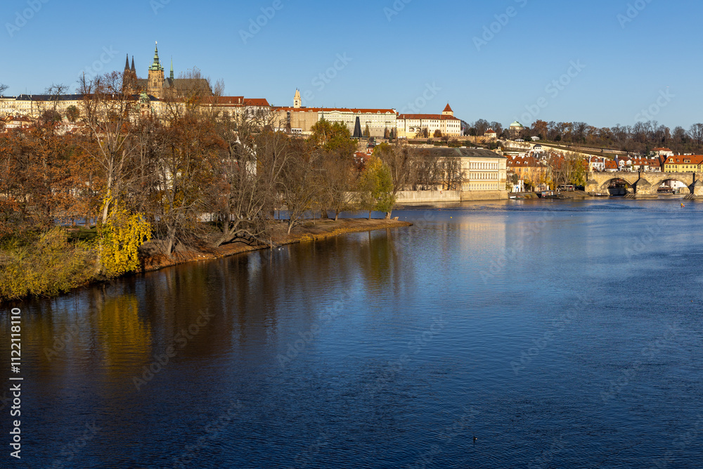 Fototapeta premium Autumn sunny morning over the Vltava River in Prague with a view of the historic Charles Bridge and Prague Castle
