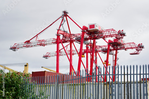 Cranes at logistics port terminal for offloading containers photo