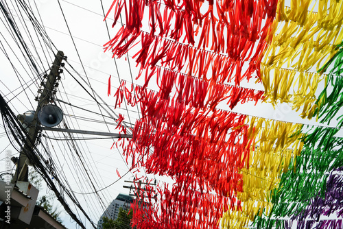rainbow decoration on the street in asia, Fair flag hanging on blue sky, party event and summer holiday farm feast celebration, celebrating lgbt, carnival festival, park or street design decoration