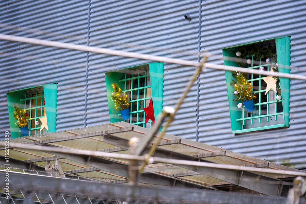 Naklejka premium Christmas decoration outside of barred windows of deportation prison at Zurich Airport on a rainy autumn day. Photo taken December 7th, 2024, Zurich Kloten, Switzerland.