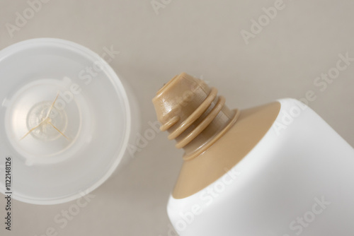 Open white brown moisturizer cream tube minimal, close-up