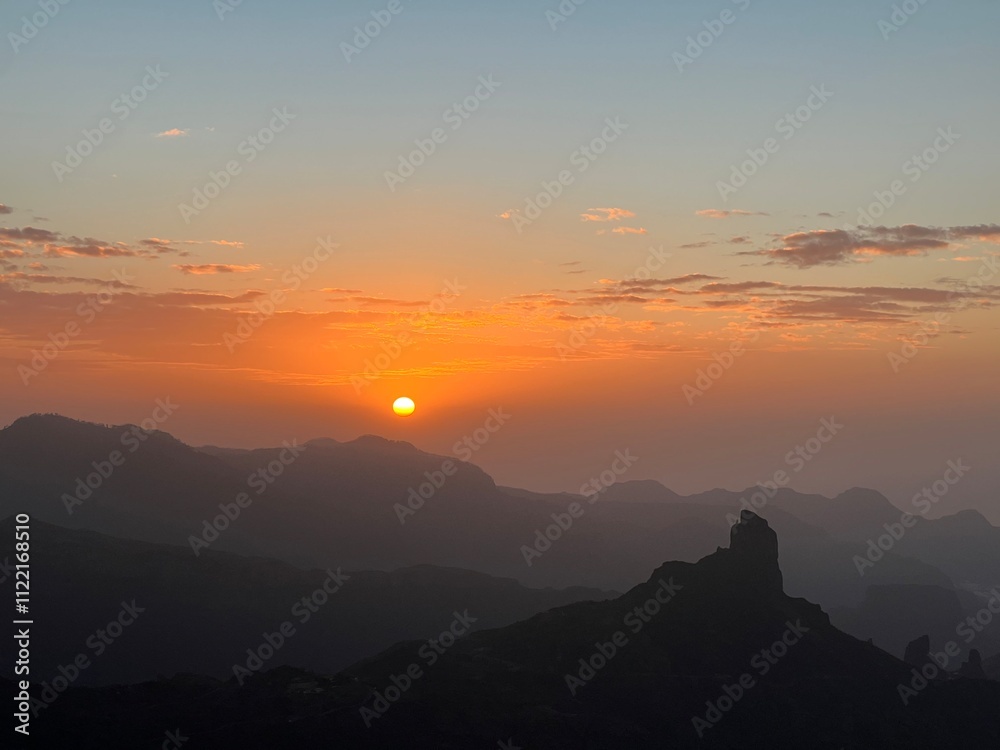 Obraz premium Roque Bentayga is a rock formation on the island of Gran Canaria. Wonderful view to Rogue Bentayga from evening walk in mountain trail. Sunset view.