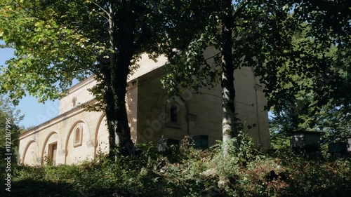 Historic Georgian church nestled in the woods surrounded by lush greenery