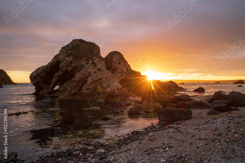 This is the sea arch at Ballintoy on the north coast of Ireland. This was taken at low tide leaving tidel pools reflecting the sky photo