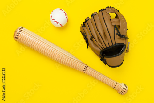 Baseball glove and bat with ball on color background, top view photo