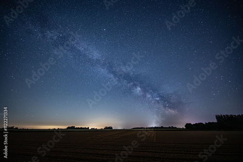 Milky way over farm land in Normandy and rising moon, natural countryside landscape under summer starry night, Night of the Stars (Nuit des Etoiles) photo