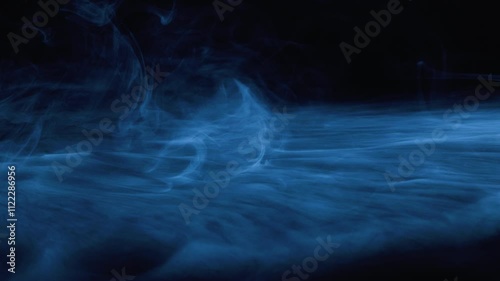 Abstract image of dark room concrete floor. Black room or stage background for product placement.Panoramic view of the abstract fog. White cloudiness, mist or smog moves on black background. 