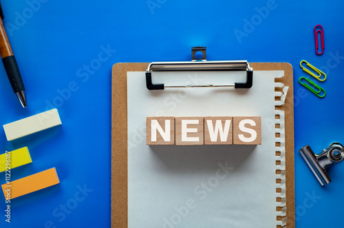 There is wood cube with the word NEWS. It is as an eye-catching image. photo