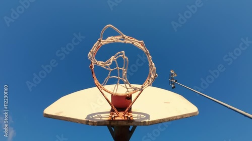 Basketball Flies Through The Air And Lands Precisely In The Hoop. Slow Motion Shows The Ball Trajectory And The Net Reaction From A Unique Angle Beneath The Basket.