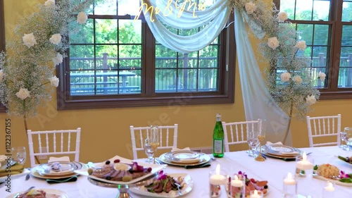 Wedding jewelry. Wedding table with plates, chairs, napkins, decorative fresh and dried flowers, candles and light bulbs.