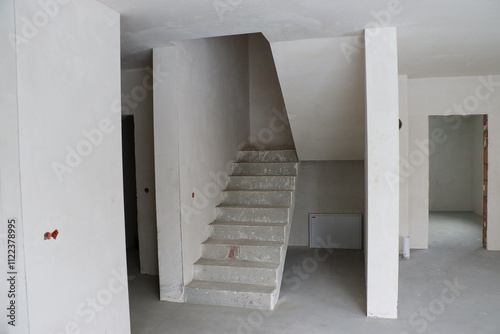 monolithic staircase, house before renovation, empty walls, construction 