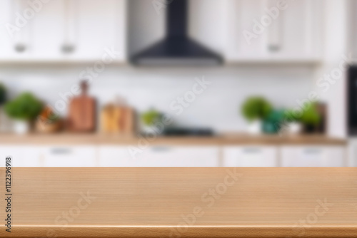 Kitchen wood table top for product display with blurred modern interior. Wooden tabletop over defocused kitchen background. kitchen furniture and desk space. product promotion in the kitchen