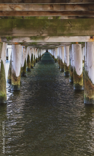 Photo of water under wooden pier in the sea, Sea pier pillars, photo of long pier, perspective