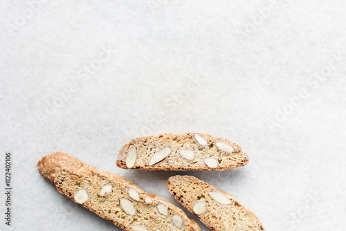 overhead view of almond biscotti on white marble countertop, top view of almond cantucci cookies on a white board, flatlay of slices of biscotti cookies or twice baked cookies