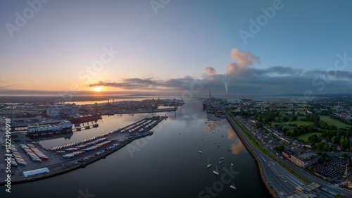 The image showcases a bustling waterfront scene at Dublin Port, featuring a modern bridge spanning across the harbour in Dublin Ireland photo