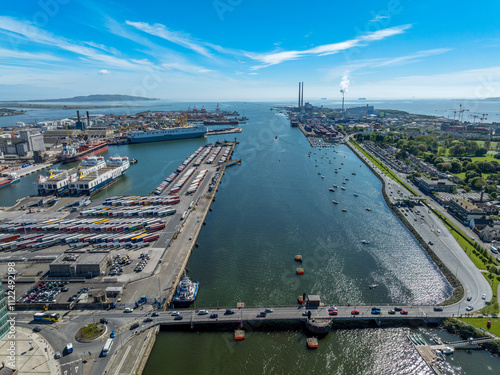 The image showcases a bustling waterfront scene at Dublin Port, featuring a modern bridge spanning across the harbour in Dublin Ireland photo