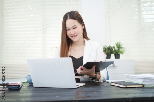 Free Download A young, professional businesswoman working at her desk in an office, providing online legal consultancy for disputed civil cases, addressing lawsuits, loan defaults, unfair dismissals, and property - GFXLoad