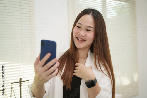 A cheerful businesswoman works at her office desk as a legal consultant, handling online civil cases, including debt disputes, unfair dismissals, foreclosures, land redemptions, with professionalism photo