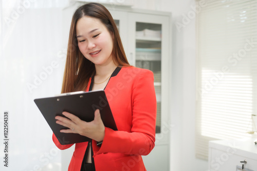 A cheerful businesswoman works at her office desk as a legal consultant, handling online civil cases, including debt disputes, unfair dismissals, foreclosures, land redemptions, with professionalism photo