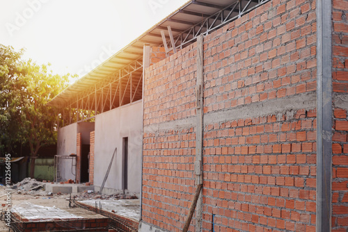 A building under construction made of red bricks