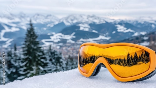 Ski goggles reflect a stunning mountain landscape covered in snow, showcasing a perfect winter day for adventures.