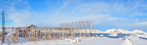 Obraz na płótnie Panoramic view of fish drying rack and snow mountain at Norway. w salonie