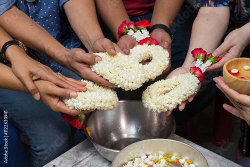Hands give Thai jasmine garland to the mother, father and Adults with respect, Festival Songkran Day.