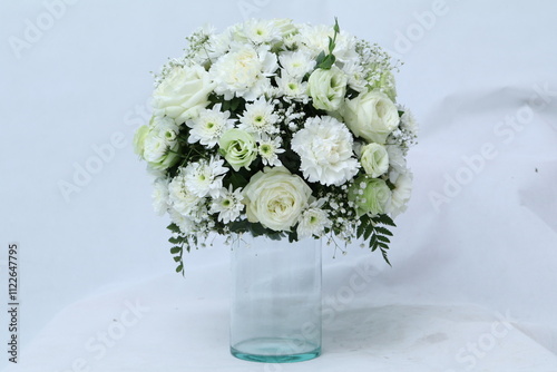 Many kinds of flowers placed in a brightly colored vase