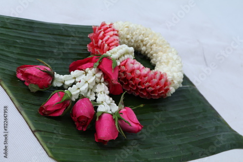 Many kinds of flowers placed in a brightly colored vase