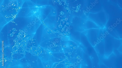 Blue water surface with wave action and numerous air bubbles, fluid dynamics, air bubbles