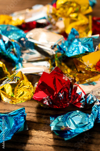 Colorful candy wrappers scattered on a wooden table