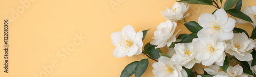 Blooming bouquet of spring flowers on yellow pastel background. Flat lay. Top view. Banner copyspace. Wedding invitation template. Mother's Day or Women's Day greeting card.