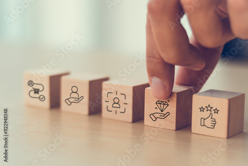 Exceptional service concept. Wooden blocks with exceptional service icons. Providing a positive, helpful and timely experience for customers above and beyond the customer's expectation.