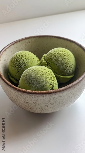 Savoring matcha ice cream scoops in a natural ceramic bowl soft and inviting presentation