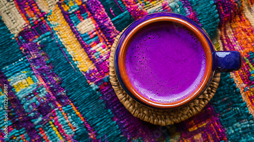 Overhead shot of a vibrant purple mazamorra with chicha morada in a traditional earthenware mug photo