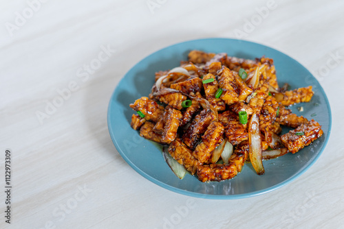 Side view of food background with traditional Indonesian food called tempe orek on marble background